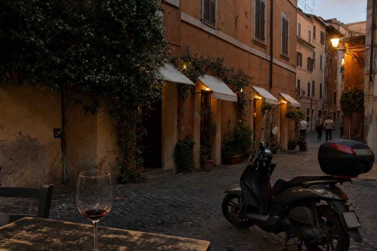 A quiet Roman side street with plain trattoria awnings at dusk