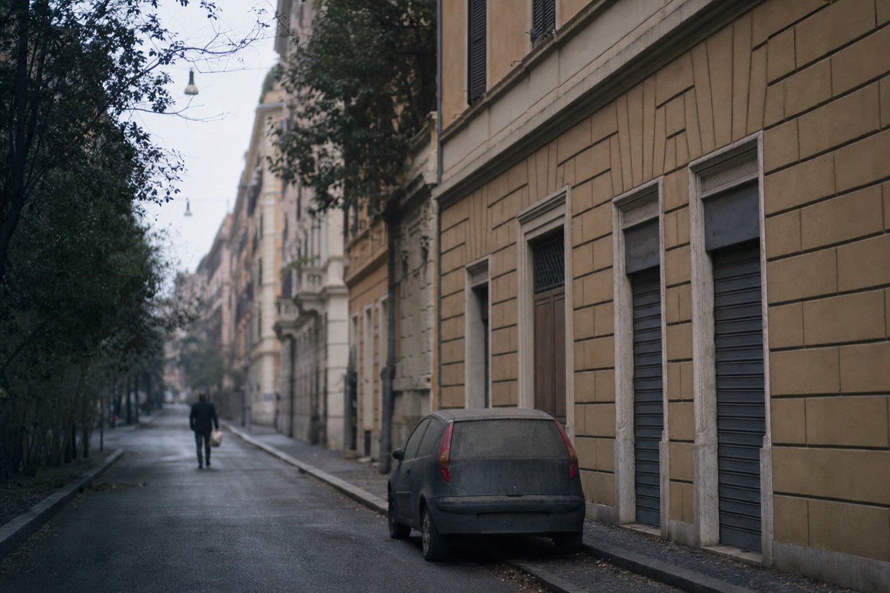 A quiet side street in Prati with shuttered shopfronts near the Vatican