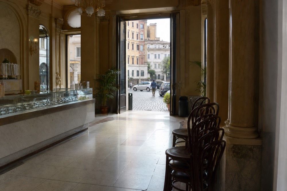 A spacious vintage gelato hall with tiled floors and counters in Rome