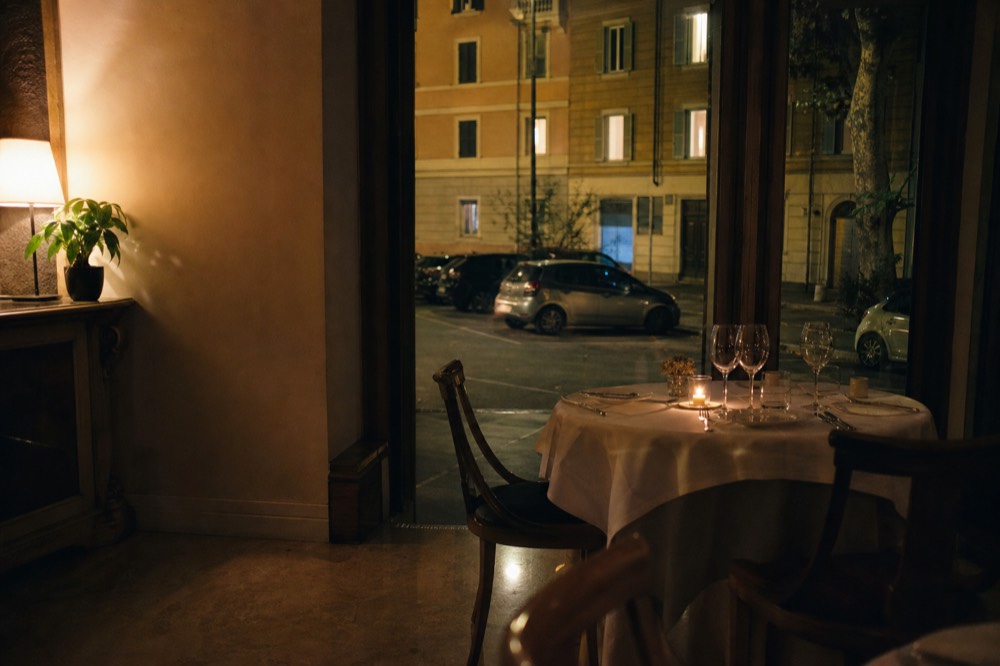 Empty elegant restaurant table set for dinner with candles