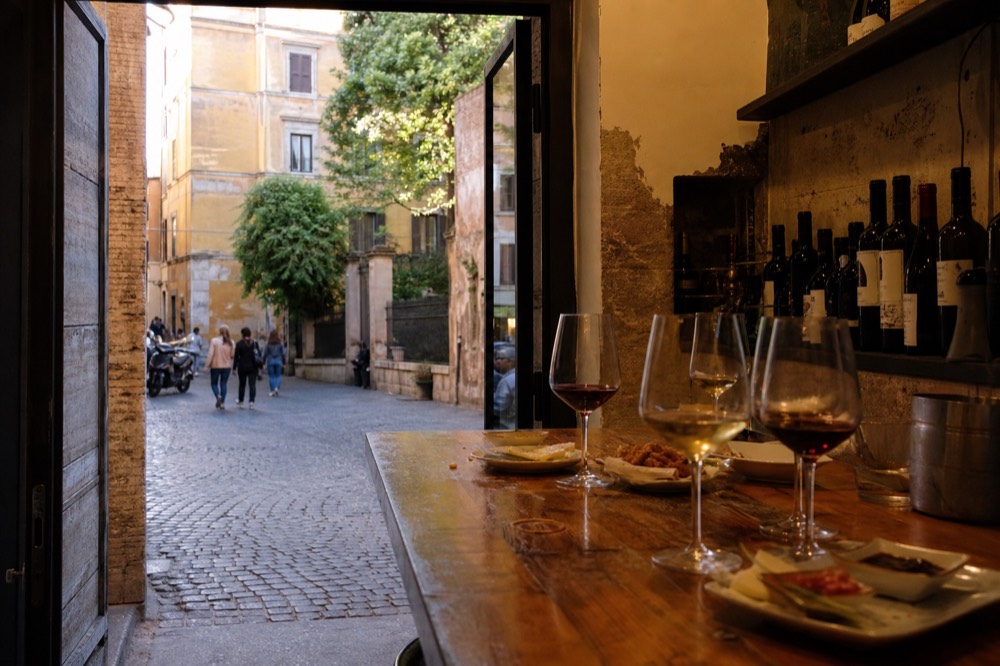 Wine glasses and small plated tastings on a wooden counter
