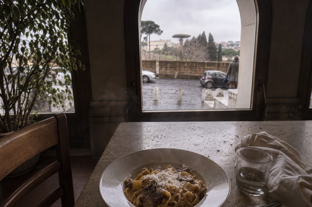 Fresh pasta course plated in a Roman dining room