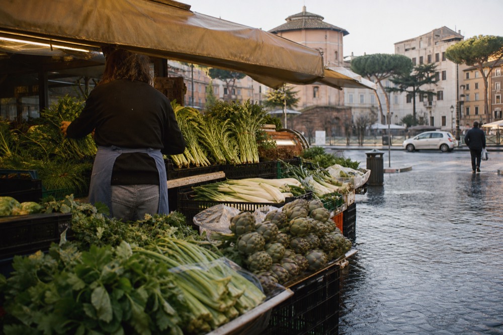 A Rome market stall of fresh vegetables and herbs in morning light