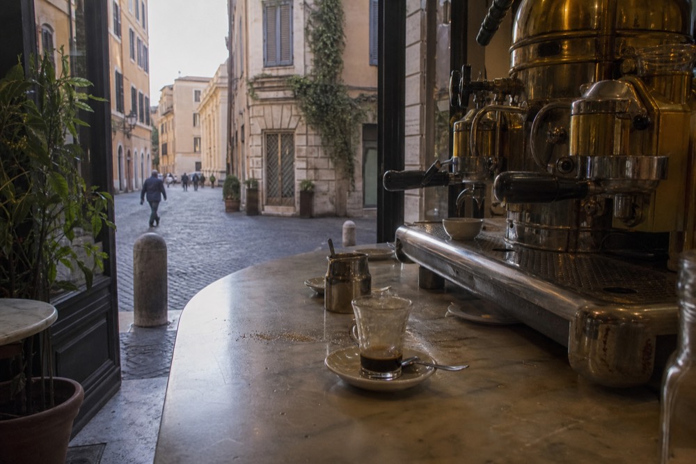 A historic café counter with an espresso machine in Rome