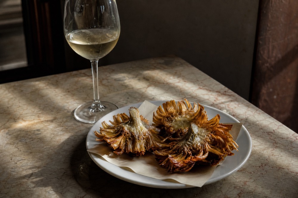 Golden fried artichokes on a plate in a Roman restaurant