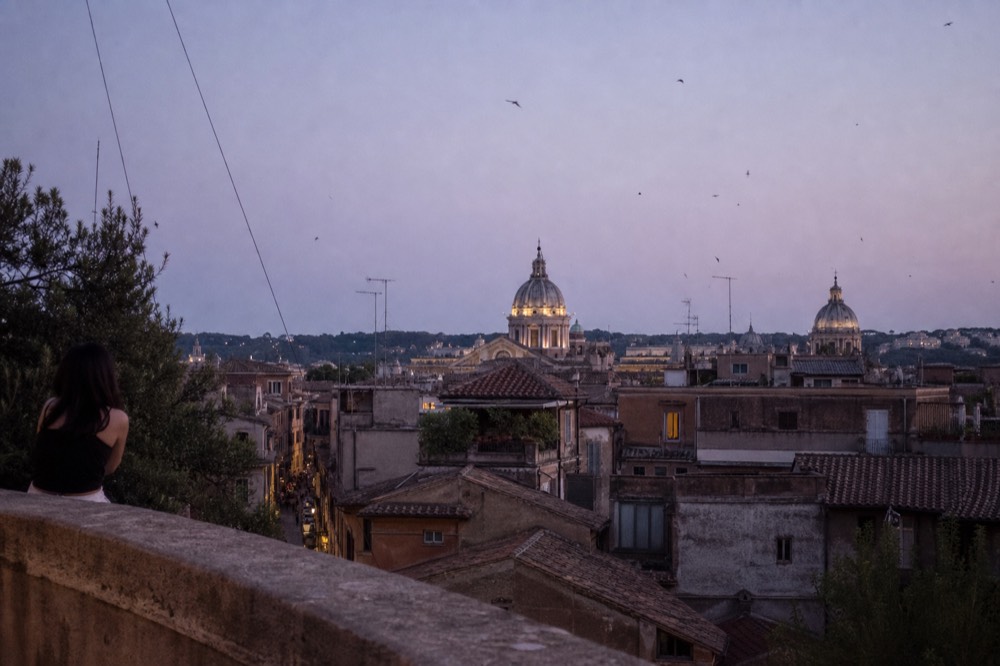 Evening view over Rome rooftops and domes from a high terrace