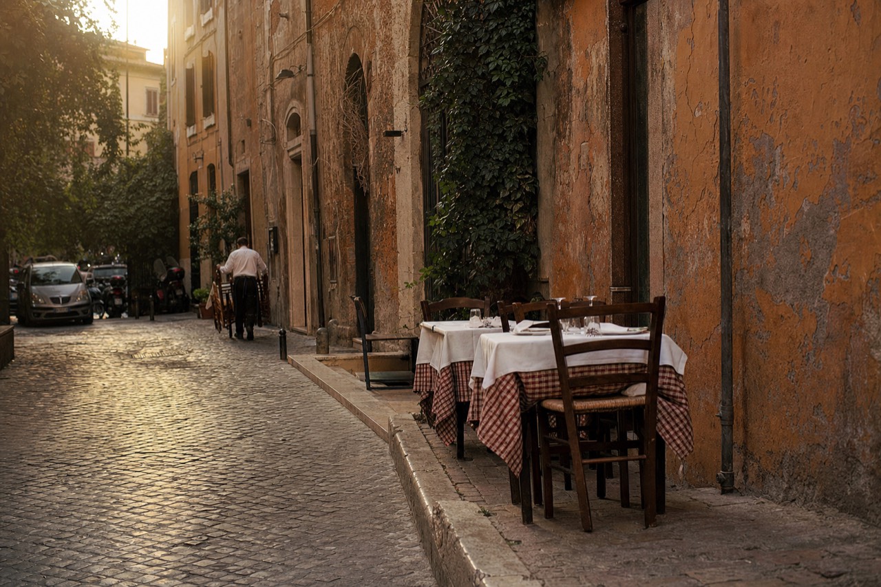 A quiet Roman side street with a trattoria sign and empty tables